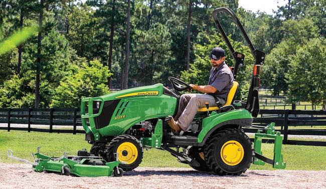 Man showing off his new John Deere 1023 E on his farm. Image source: Compactequip.