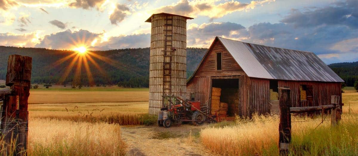 Old barn and small tractor in the sunset. It might need some work, but it's a beauty. Photo by our friend Timothy Eberly.